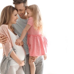 אחות גדולה נוגעת בבטן ההריונית של אמה