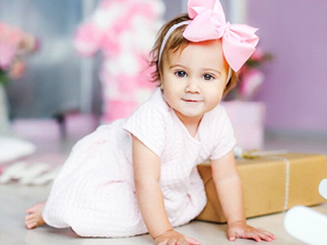 תינוקת עם סרט ורוד לראשה