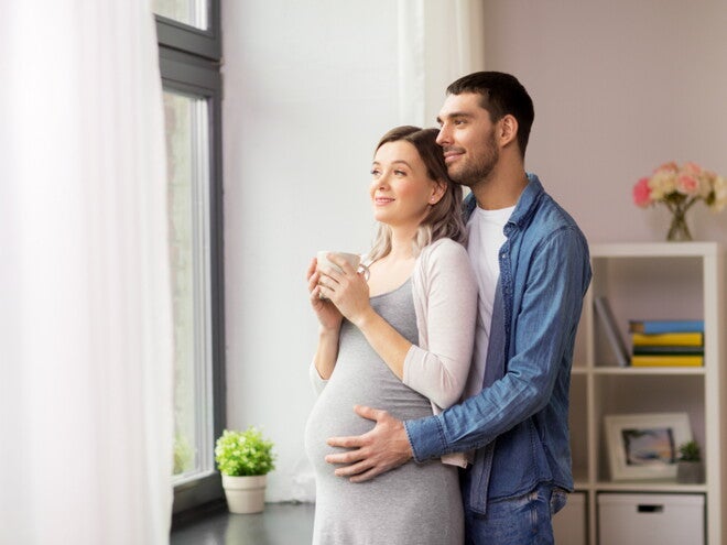 גבר מחבק את אישתו ההרה